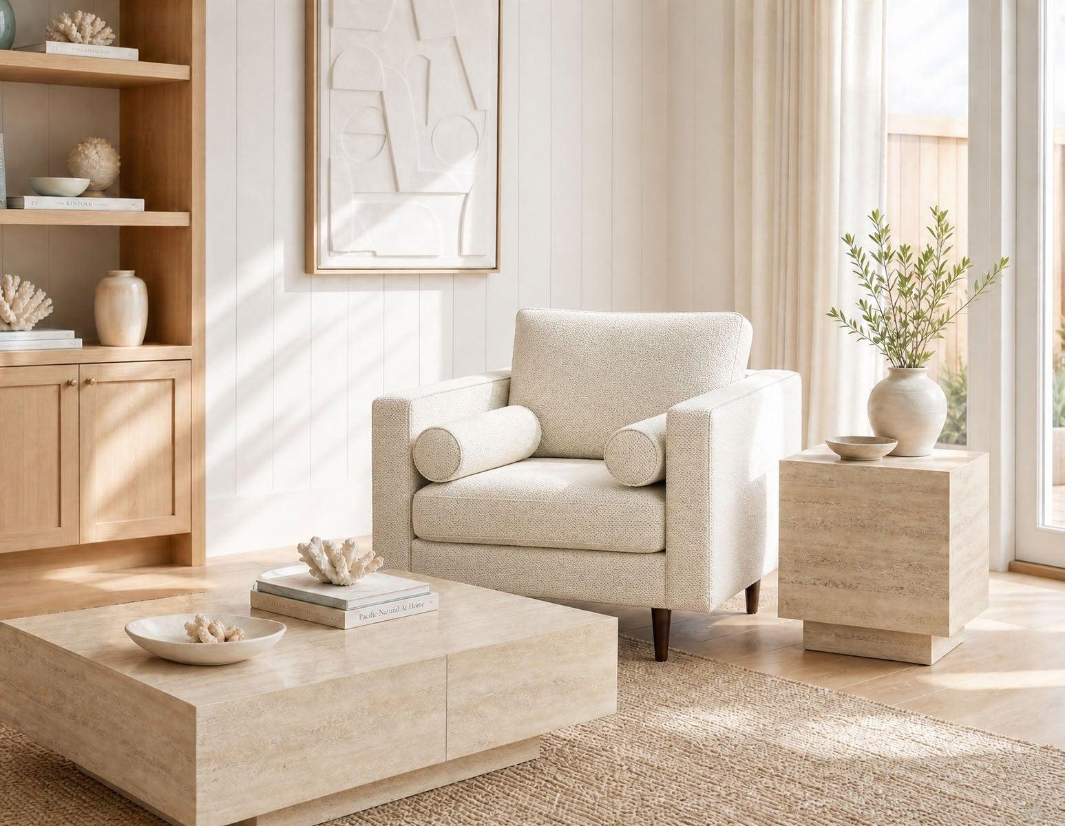 Calm, sunlit living room with a cream armchair and soft natural textures